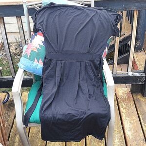 Little Black Dress- Polyester and Cotton. Belt straps and two pockets built in.